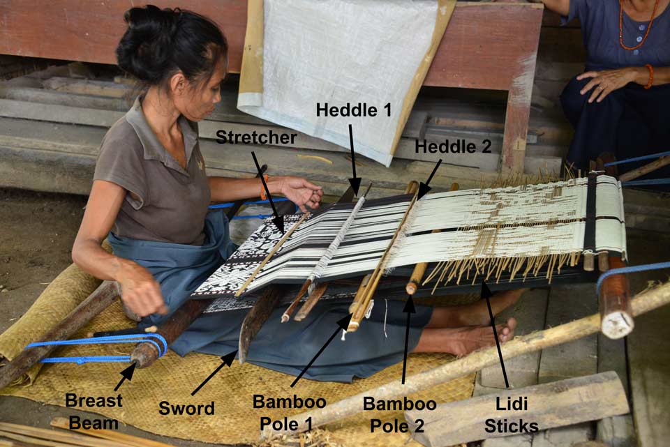 Description: A young weaver at Pau working on the lower panel of a lau pahikung