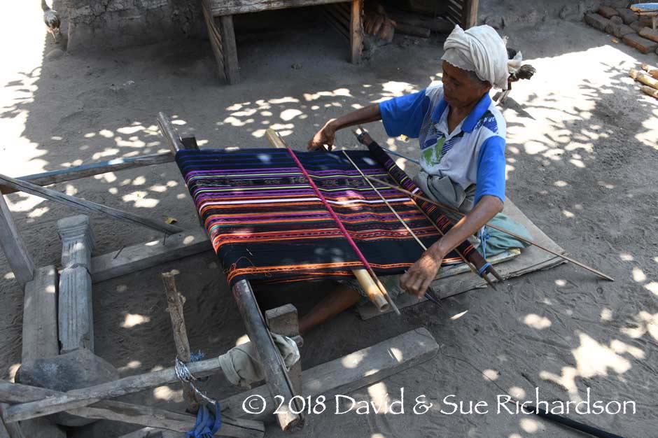Description: Weaving a sarong with chemical stripes and naturally dyed bands of ikat