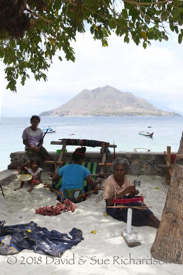 Description: Women working under the sade of a tree, while overlooking Ternate Island