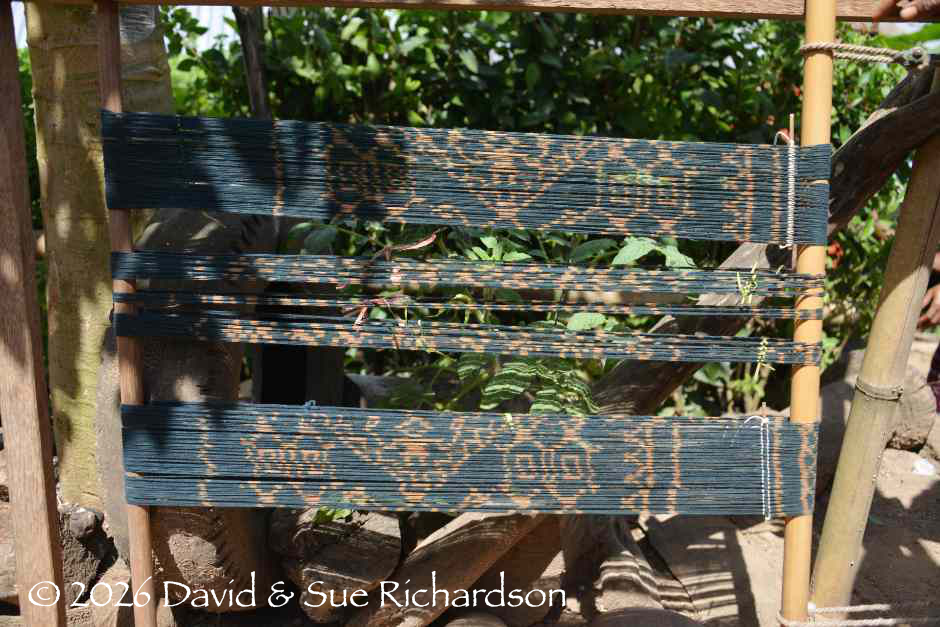 Description: Indigo dyed ikatted mata locked in alignment with short snigi sticks