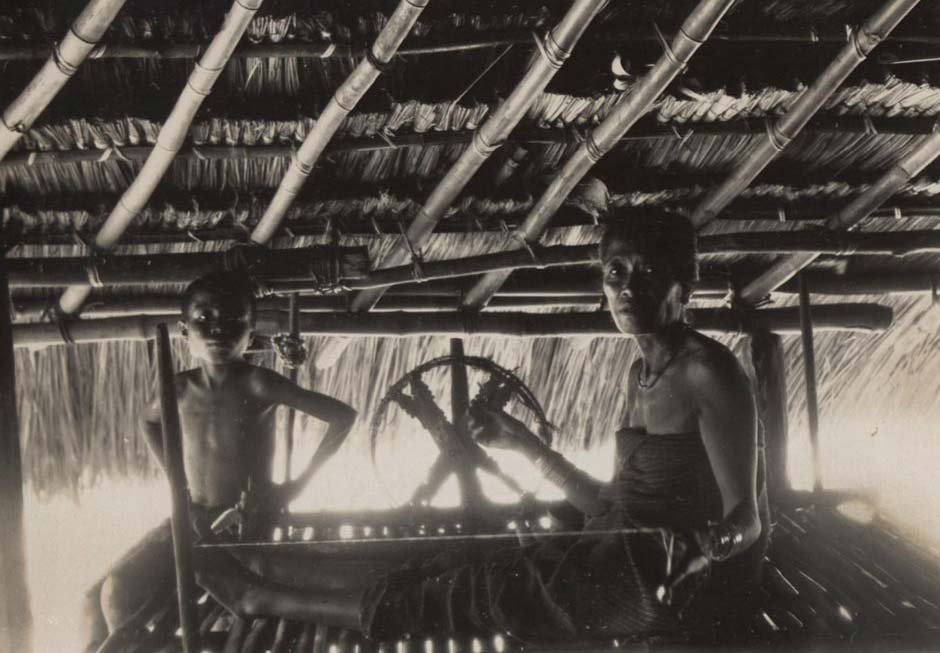 Description: Woman and spinning wheel