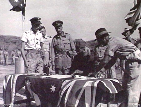 Description: Lieutenant General Yamada signing the surrender document